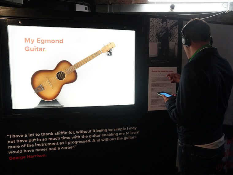 Daniel Taylor and George Harrison's first guitar at The Beatles Story museum in Liverpool.