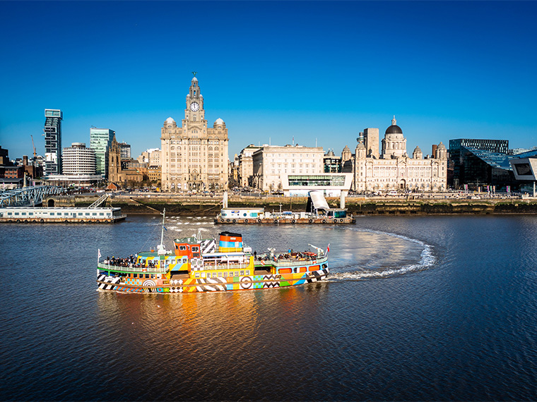 mersey ferries dazzle boat in front of the liverpool waterfront